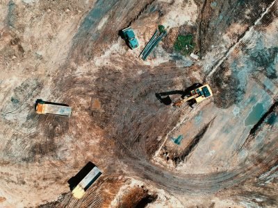 pexels-photo-1188553-1188553 High-angle aerial view of construction site with earthmoving equipment and trucks.
