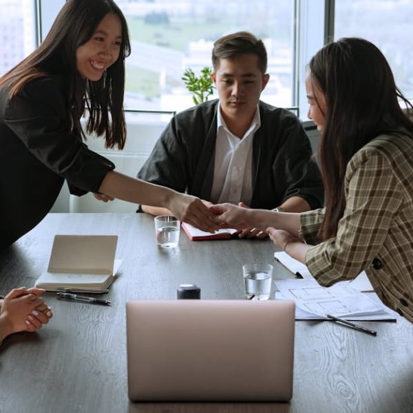 A diverse group of professionals collaborating in an office meeting, fostering teamwork and innovation.